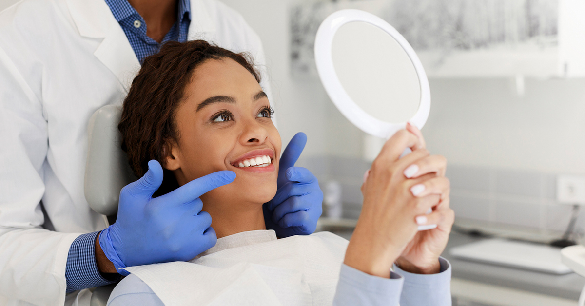 woman looking at smile at the dentist's office