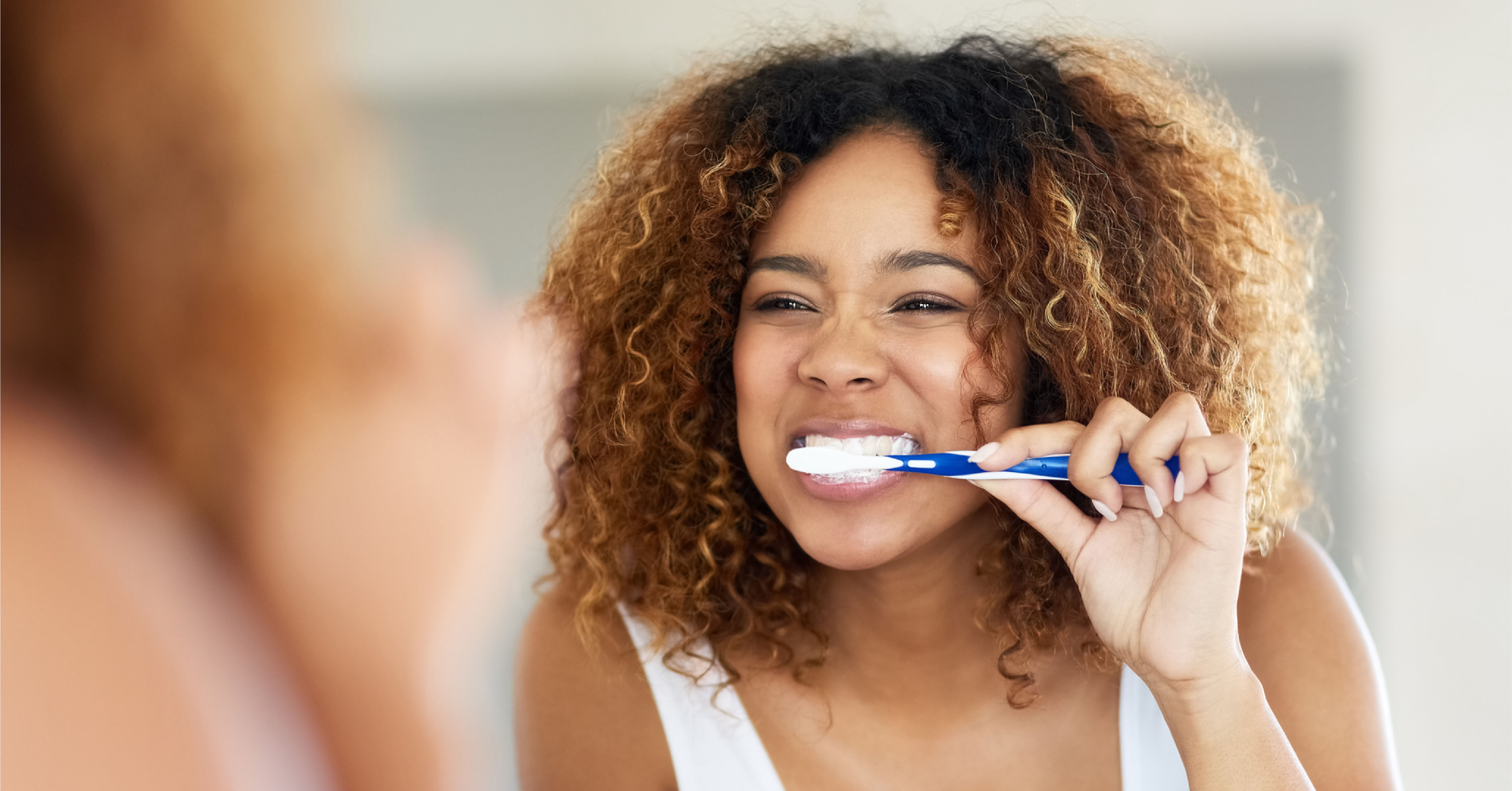 woman brushing her teeth